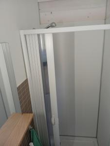 a shower in a bathroom with a glass door at Filuvespri in Comiso