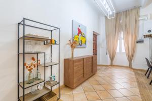 a living room with a wooden cabinet and a mirror at Ca'Mea 2 Vista Mare, vicino alla pista ciclabile in Imperia