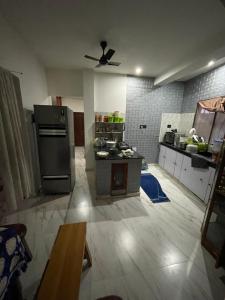 a kitchen with a refrigerator and a table in it at Lotus home in Jaigaon