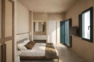 a bedroom with a bed and a mirror and a window at Astypalaia Hotel Palace in Astypalaia