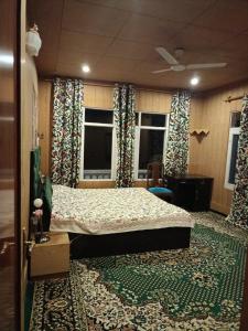 a bedroom with a bed and a large rug at Bunk Home stay in Srinagar +8 photos