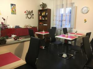 two tables in a restaurant with red and black chairs at Mia Palace in Florence