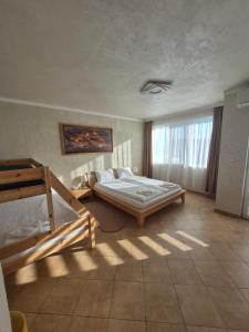 a bedroom with two bunk beds and a window at Апартаменти Ванкови 2 in Veliko Tŭrnovo