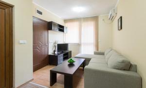 a living room with a couch and a table at Guest House La Casa in Varna City