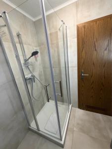 a shower with a glass door in a bathroom at Hotel Adria Stuben in Koblenz +41 photos