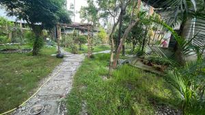 a garden with a path leading to a house at Lotus home in Jaigaon