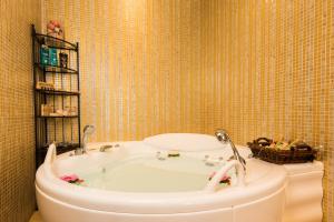 a bathroom with a bath tub and a toilet at Lindos Villa Estelle in Lindos +38 photos