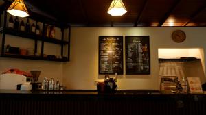 a bar with a counter top with a chalkboardledged at Swastika Bungalows in Sanur