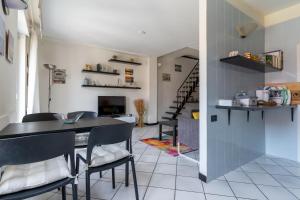 a kitchen with a table and chairs in a room at Cà Mea SUL PORTO DI ONEGLIA in Imperia