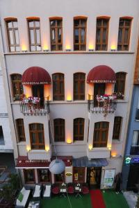 a large white building with red balconies and tables at Diamond Royal Hotel in Istanbul