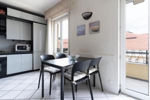 a kitchen and dining room with a table and chairs at Cà Mea SUL PORTO DI ONEGLIA in Imperia