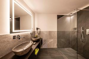 a bathroom with a sink and a shower at Apartments Aois 4 Elements Suites in La Valle +29 photos