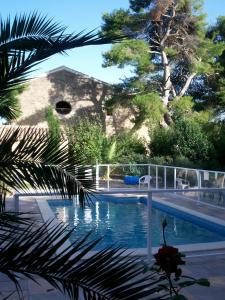 a view of a swimming pool in a resort at Domaine de la Pinsonnière in La Livinière