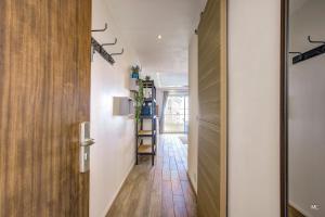 a hallway with white walls and wooden floors at WIlson Palace - Studio avec terrasse et climatisation in Antibes
