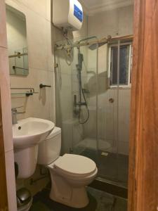 a bathroom with a toilet and a shower and a sink at Esthelixapartment in Madina +12 photos