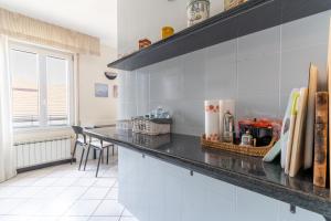 a kitchen with a counter top and a table at Cà Mea SUL PORTO DI ONEGLIA in Imperia +27 photos