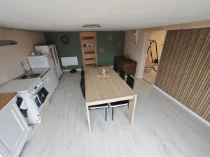 a kitchen with a wooden table in a room at Chambre à louer in Bonnétable