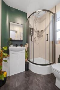 a bathroom with a shower and a sink at Ramsay Lane in Lossiemouth