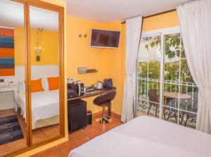 Postel nebo postele na pokoji v ubytování Boutique Hotel Pueblo