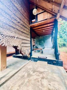 an outside view of a house with a wooden ceiling at Sigiriya Coconut Shade Resort in Sigiriya