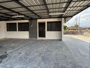 a garage with awning on top of a building at KH Homestay in Kampong Batu Lapan