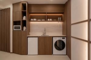 a kitchen with a sink and a washing machine at StayShim in Seoul