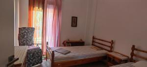 a small bedroom with a bed and a window at AVRA House in Karfas