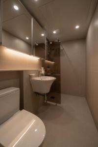 a bathroom with a sink and a toilet and a mirror at StayShim in Seoul +41 photos