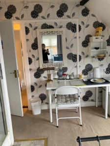 a person taking a picture of a bathroom with a sink at House on the Corner B&B in Didcot