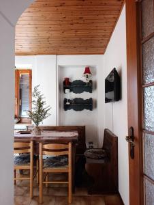 a dining room with a table and a chair at Da Anny - Valdilana in Coggiola