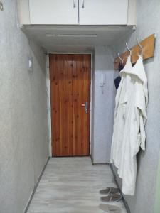 a hallway with a wooden door and a closet at Airport 24h in Chişinău +1 photo