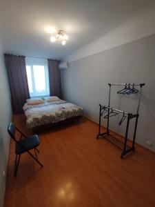a bedroom with a bed and a chair in it at Airport 24h in Chişinău
