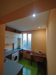 a kitchen with a sink and a washing machine at Airport 24h in Chişinău