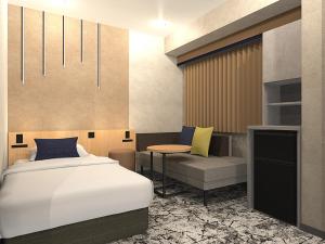 a bedroom with a bed and a table and a chair at Hotel Keihan Kyobashi Grande in Osaka +109 photos