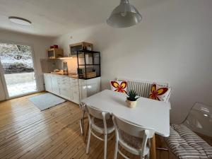 a kitchen and dining room with a table and chairs at Family Friendly Mountain House in Eisenerz