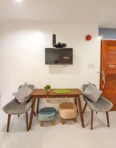 a wooden table with two chairs and a table with a tableweredotentotent at Natos Residences - Gonzaga in Bacolod