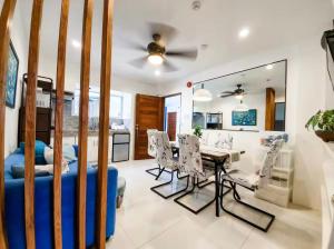 a living room with a blue couch and a table and chairs at Natos Residences - Gonzaga in Bacolod