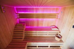 a small sauna with purple lighting in a room at Domki u Niedźwiadka in Wola Sękowa