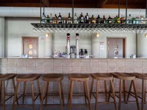 a bar with wooden stools in a restaurant at Ibis Valencia Alfafar in Alfafar