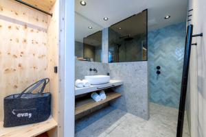 a bathroom with a sink and a shower at eva,GARDEN in Saalbach-Hinterglemm +60 photos