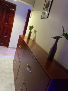 a dresser with two vases sitting on top of it at Binyuma Suites Motel in Kampala