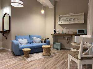a living room with a blue couch and a chair at le Piagge in Viterbo