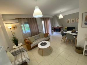 a living room with a couch and a table at Vereniki 1 in Kriopigi