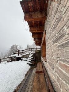 an outside of a building with snow on the ground at Artemisia Eco-Pet friendly B&B in La Salle