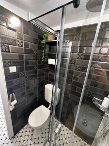 a bathroom with a toilet and a shower at Petőfi Sarok Apartman in Keszthely