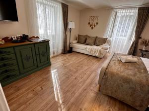 a living room with a bed and a couch at Petőfi Sarok Apartman in Keszthely +12 photos