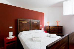 a bedroom with a large bed with two towels on it at Casa Professa Luxury Palermo Center in Palermo