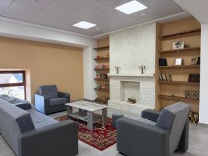 a living room with two chairs and a fireplace at KUMA Hotel Gyumri in Gyumri