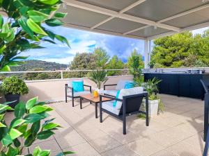 a patio with chairs and a table on a roof at Villa TeSa in Sevid