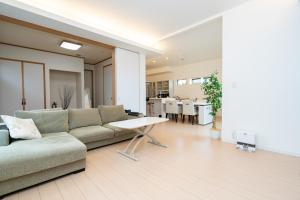 a living room with a couch and a table at ISE Resort 綾 UZ1 in Ise +24 photos